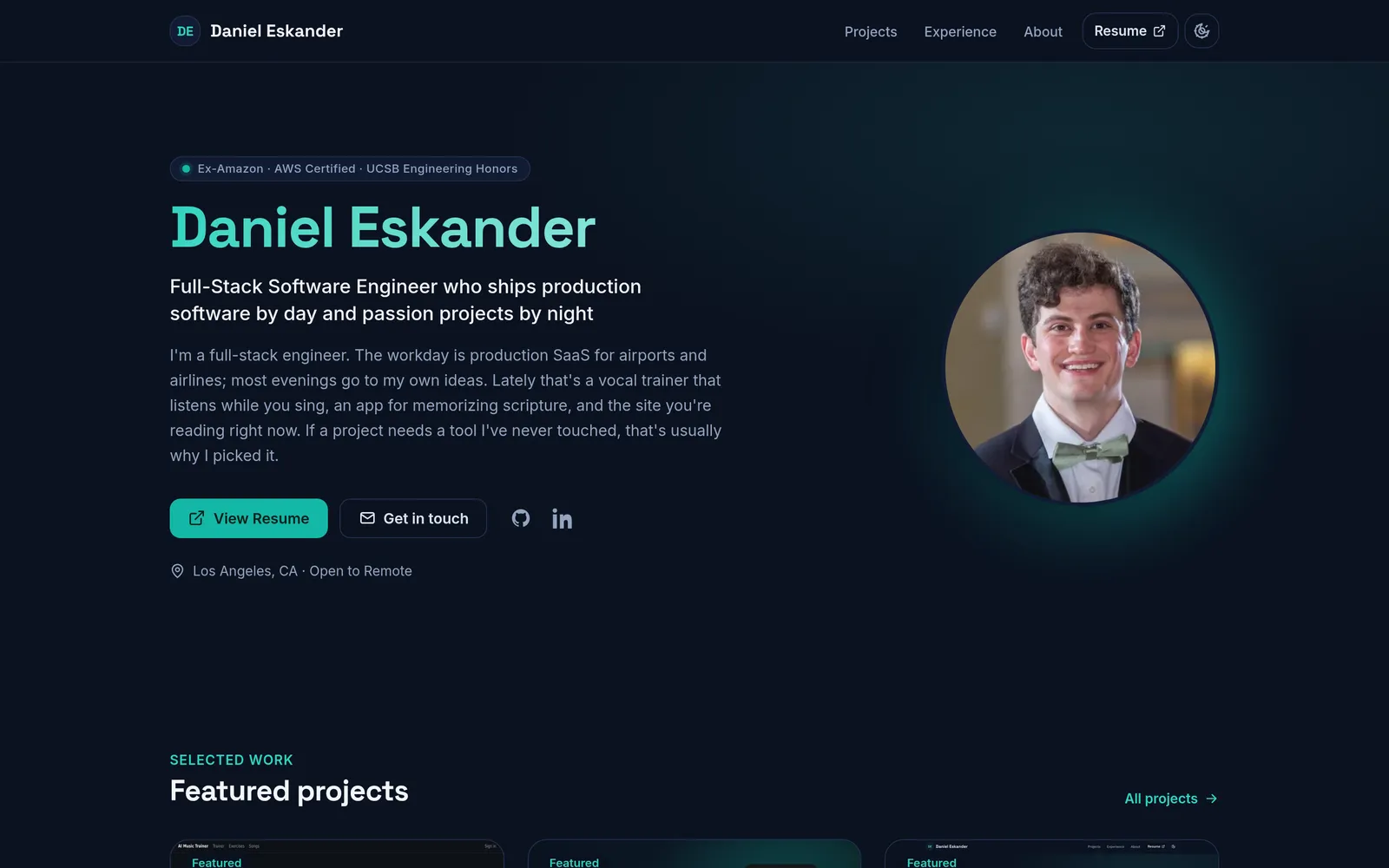 The portfolio homepage hero in dark mode: accent glow, proof-chip tagline, and headshot